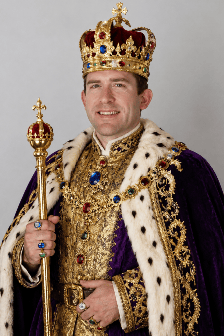 A man dressed in royal regalia, wearing a crown and ornate cloak adorned with jewels, holding a scepter, smiling against a neutral background.